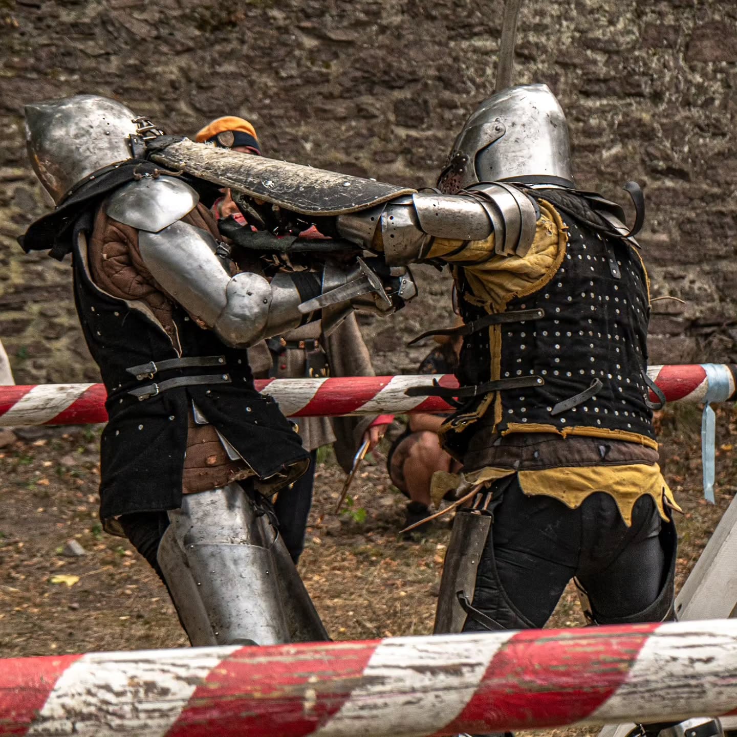 Two fighters exchanging sword strikes
