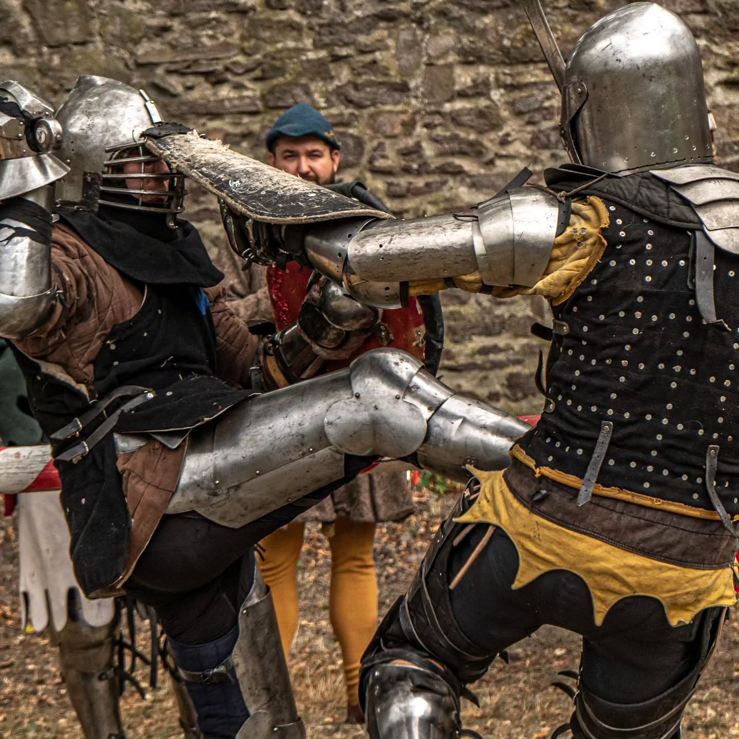 Armoured fighters competing with sword and buckler